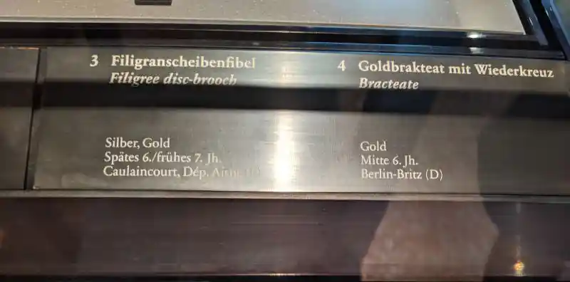 Display of a Merovingian filigree disc-brooch and gold bracteate from the 6th and 7th centuries AD